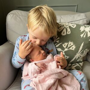 Proud big brother Harry with his little sister Lily
